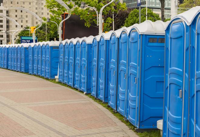 a row of portable restrooms set up for a large athletic event, allowing participants and spectators to easily take care of their needs in Coker, AL